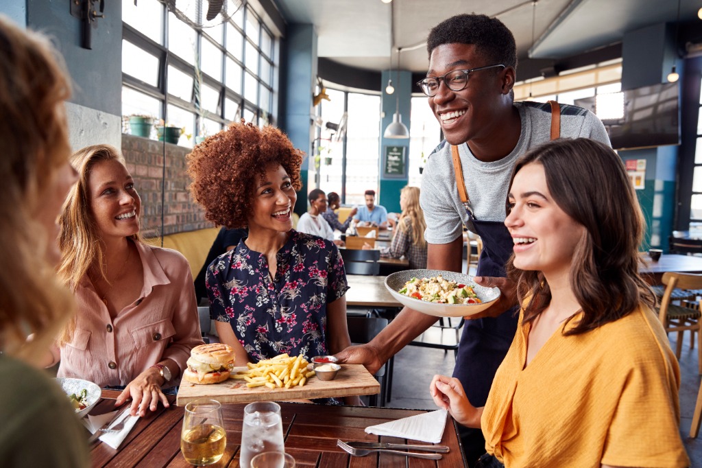 Group of friends celebrating around a dining table