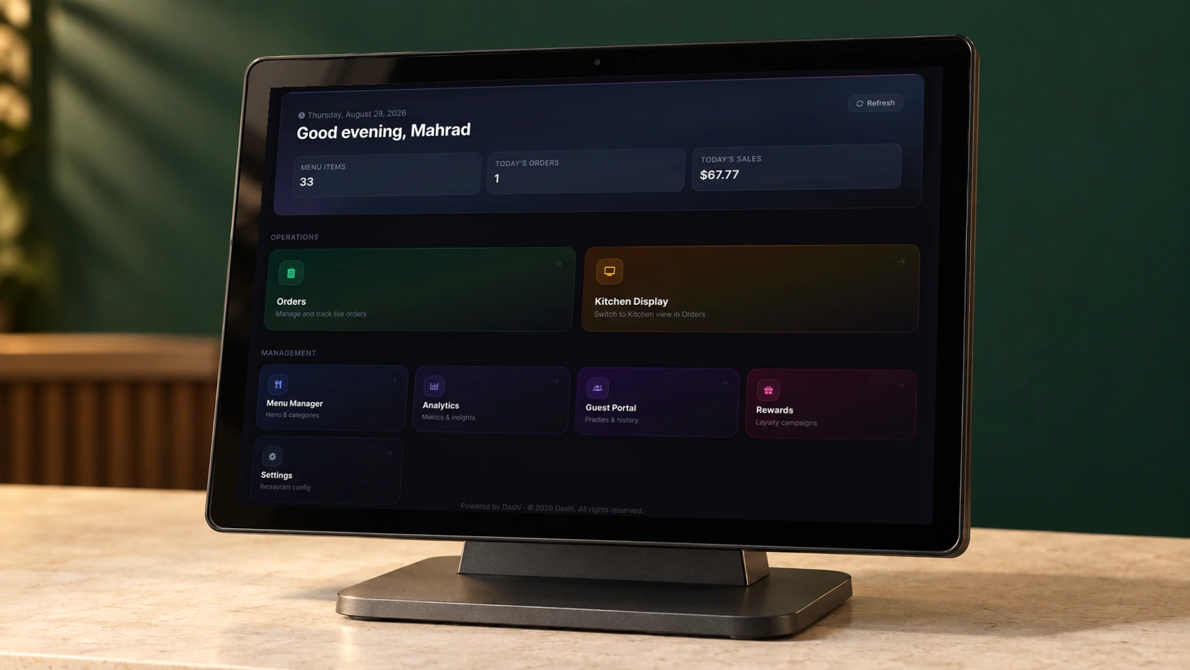 Dashi dashboard displayed on a modern countertop POS terminal against a warm green backdrop